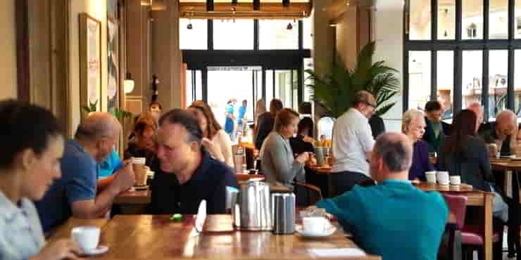A busy cafe full of socialising customers - Become WordPress Social Media Friendly